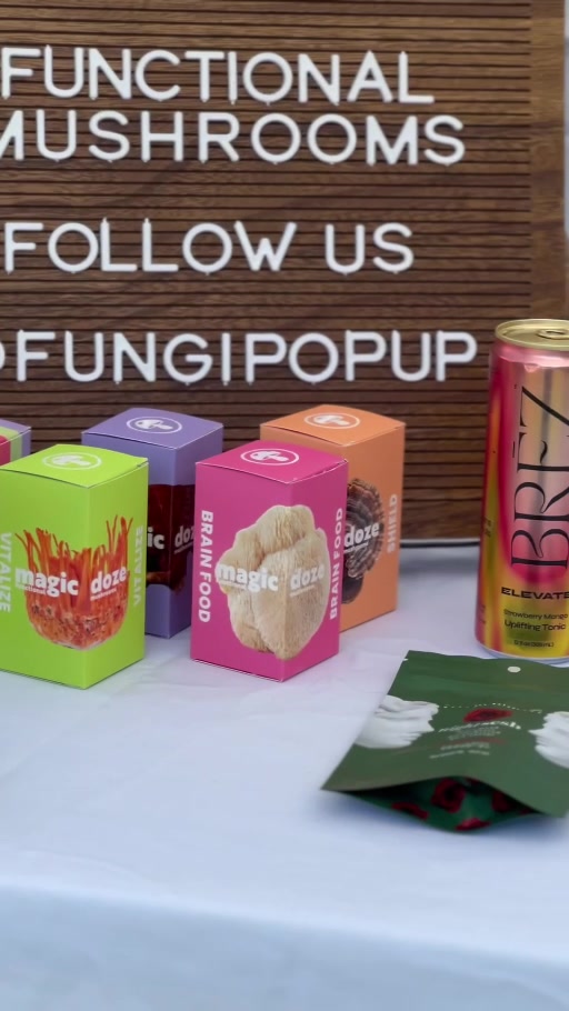 FungiPopUp event sign beside colorful mushroom product boxes and functional drink can