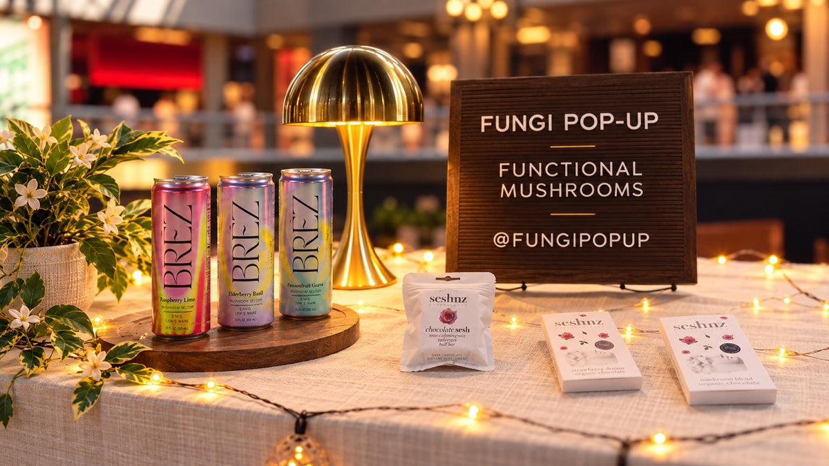 Fungi Pop-Up functional mushroom booth with BRĒZ drinks and Seshnz products on a warmly illuminated display table
